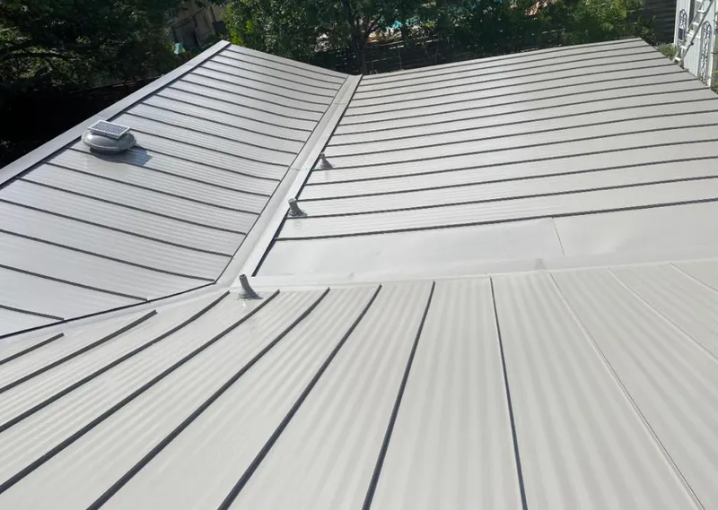 Solar attic fan installed on a metal roof for Roof Ventilation in West Bend